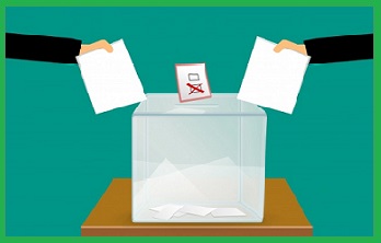 obrazek przedstawia urnę do głosowania, kartę z oddanym głosem oraz dłonie 